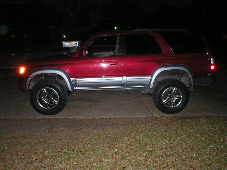 1996 Toyota 4Runner side view, red paint with silver trim, aftermarket wheels