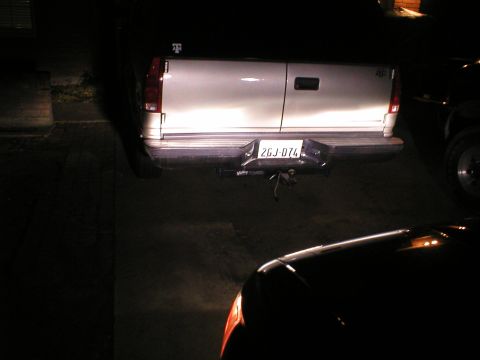 1996 Toyota 4Runner - The rear of a white pickup truck is visible, with a license plate reading 2GJ-074. Another vehicle is in the foreground.