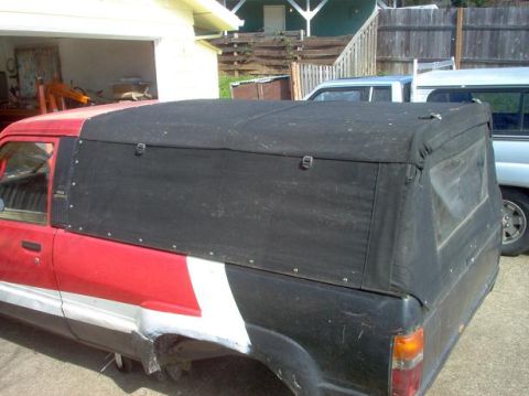 1991 Ford Explorer - A pickup truck is shown with a custom black canvas bed cover, parked next to another vehicle.