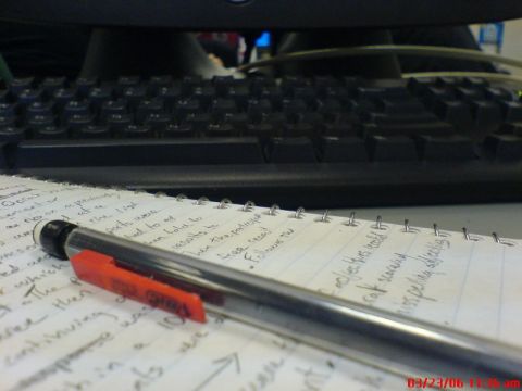 1997 Ford Probe - A close-up view of a notebook and pen resting on a desk in front of a computer keyboard.