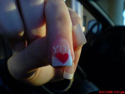 1997 Ford Probe - Close-up of a hand with painted nails, a red heart and letters.