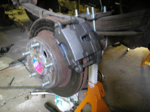 1966 Ford Bronco - The vehicle's brake system is undergoing maintenance, with the caliper and rotor clearly visible.