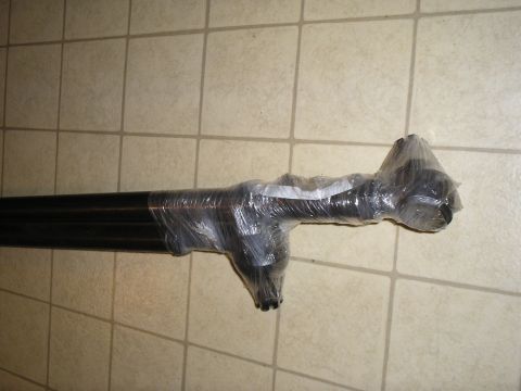 1966 Ford Bronco - This appears to be a driveshaft part, wrapped in plastic and resting on a tiled surface.