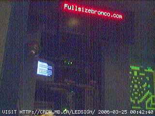 1995 Ford Bronco - A sign for Fullsizebronco.com is visible above a Supermotors.net logo in a dimly lit area.