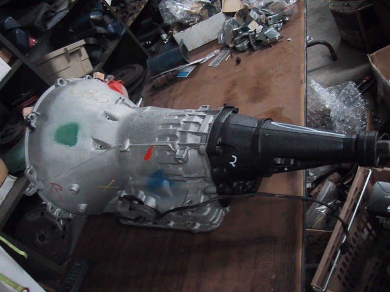 Automatic transmission with extension housing on wooden table in cluttered shop