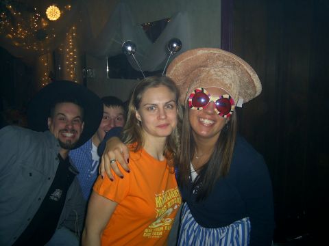 1985 Ford Bronco - People in costume enjoy a party with decorative lights in the background.