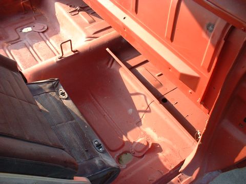 1967 Ford Ranchero - The interior of a 1967 Ford Ranchero, stripped down and painted red, awaits restoration.