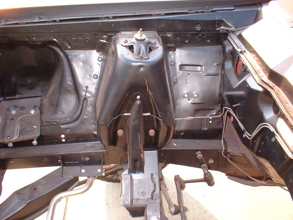 1967 Ford Ranchero engine bay, black paint, front view, showing suspension components and firewall