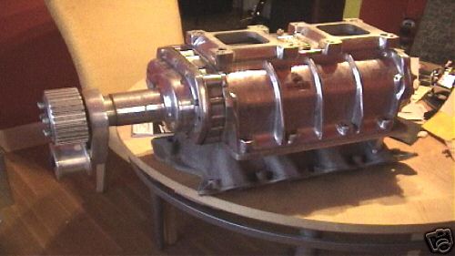 Roots-type supercharger blower with drive pulley on stand indoors