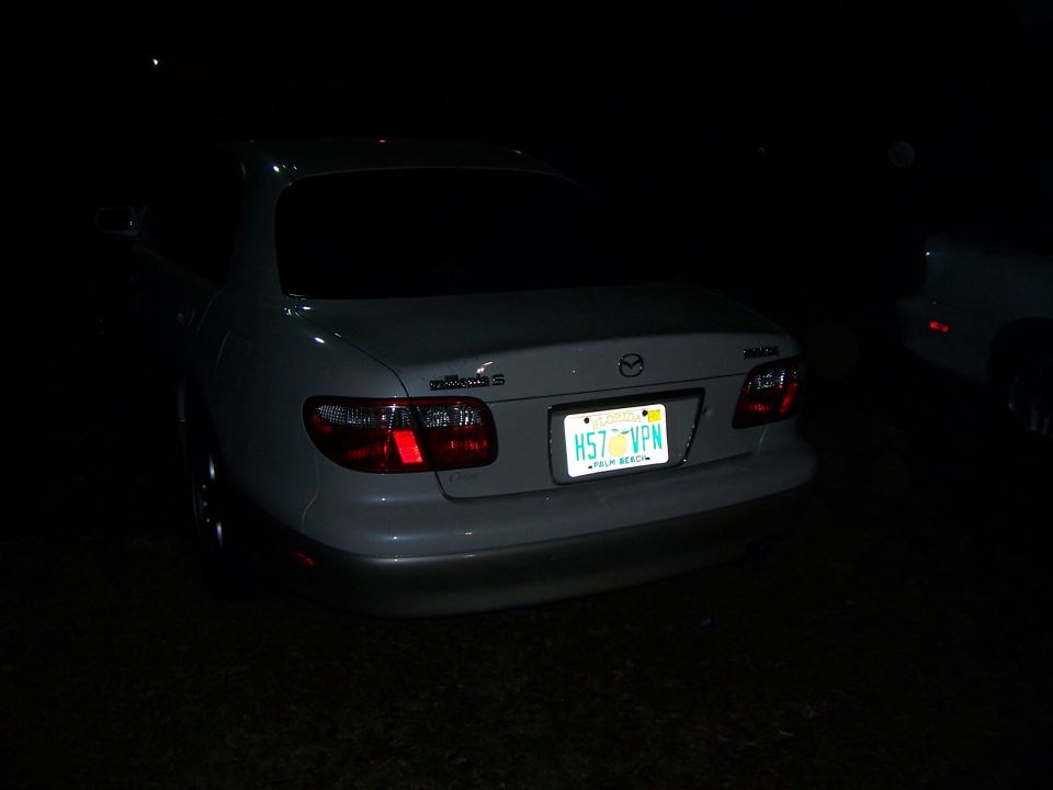White sedan with a Florida license plate H57 VPN, rear view