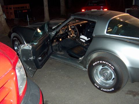 1979 Chevrolet Corvette - The interior of a 1979 Chevrolet Corvette is visible with the driver's door ajar.