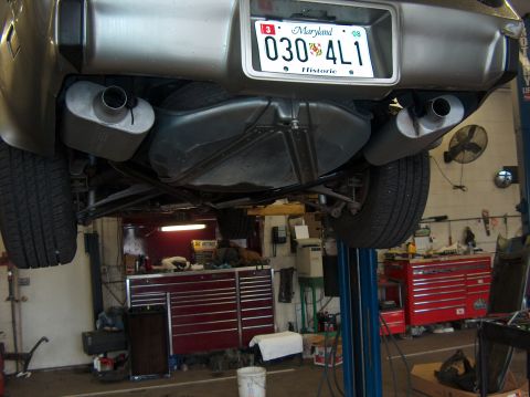 1979 Chevrolet Corvette - The rear underside of a 1979 Chevrolet Corvette is visible, dual exhaust pipes and a Maryland license plate.