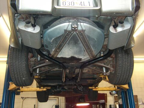 1979 Chevrolet Corvette - Underside view of a 1979 Chevrolet Corvette showing the exhaust system and spare tire storage.