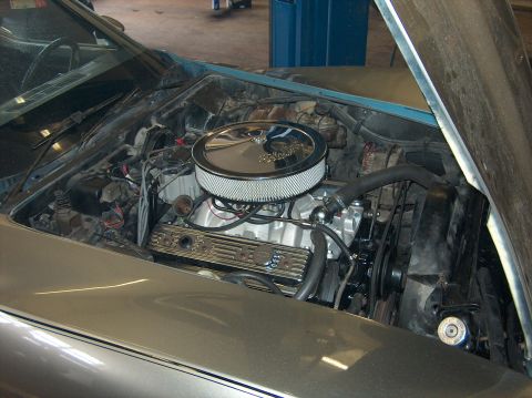1979 Chevrolet Corvette - Engine bay of a silver 1979 Chevrolet Corvette, showing the V8 engine with aftermarket chrome components.
