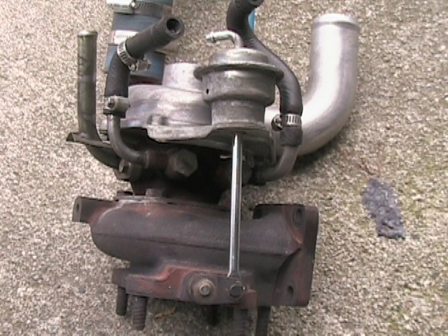 Turbocharger assembly with hoses and wastegate actuator