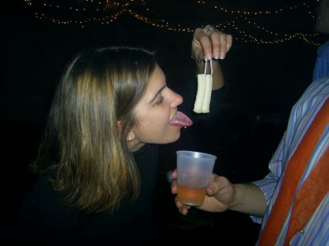 1985 Ford Bronco - A woman with a tongue piercing is about to eat food offered by another person.