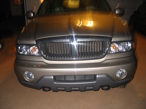 1989 Ford Bronco - Frontal view of a tan Lincoln Aviator, its distinctive chrome grille and headlights.