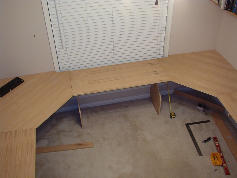 I'm just test-fitting the desktop right now.  I used my laser level to cut the tops of the 2 supports in front of the window, and the carpet is cut out so they rest on the slab.  I'll cut it out between them later.