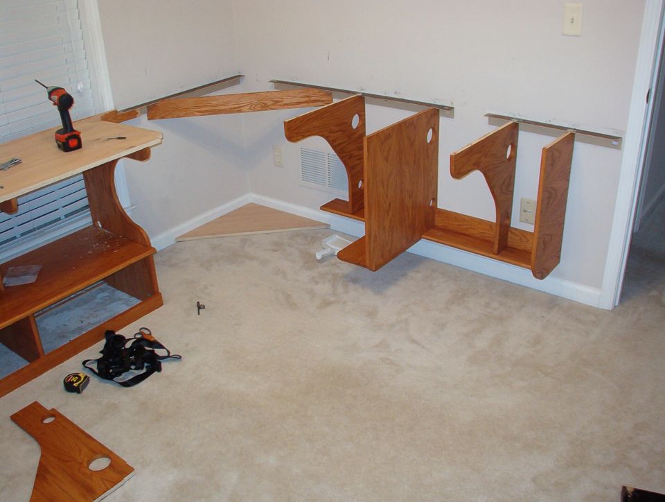 The 2 planks at the bottom were screwed & glued, then stained, and the verticals were screwed & glued on.  Then the assembly was screwed to the wall & angles as a unit.  My puter will go on the shelf of the large vertical.