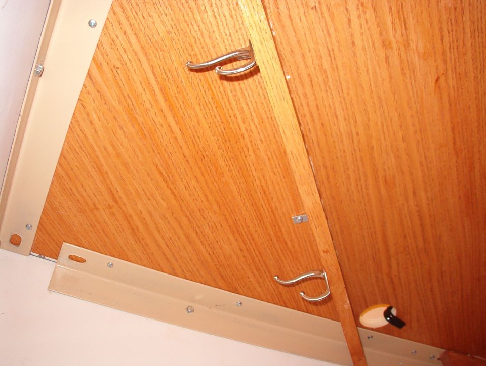 I used PLENTY of screws along the back edges to hold the desktop in place & flat, and a bunch of shelf clips to hold it down on the braces.  These coathooks are for wires that run around the corners.