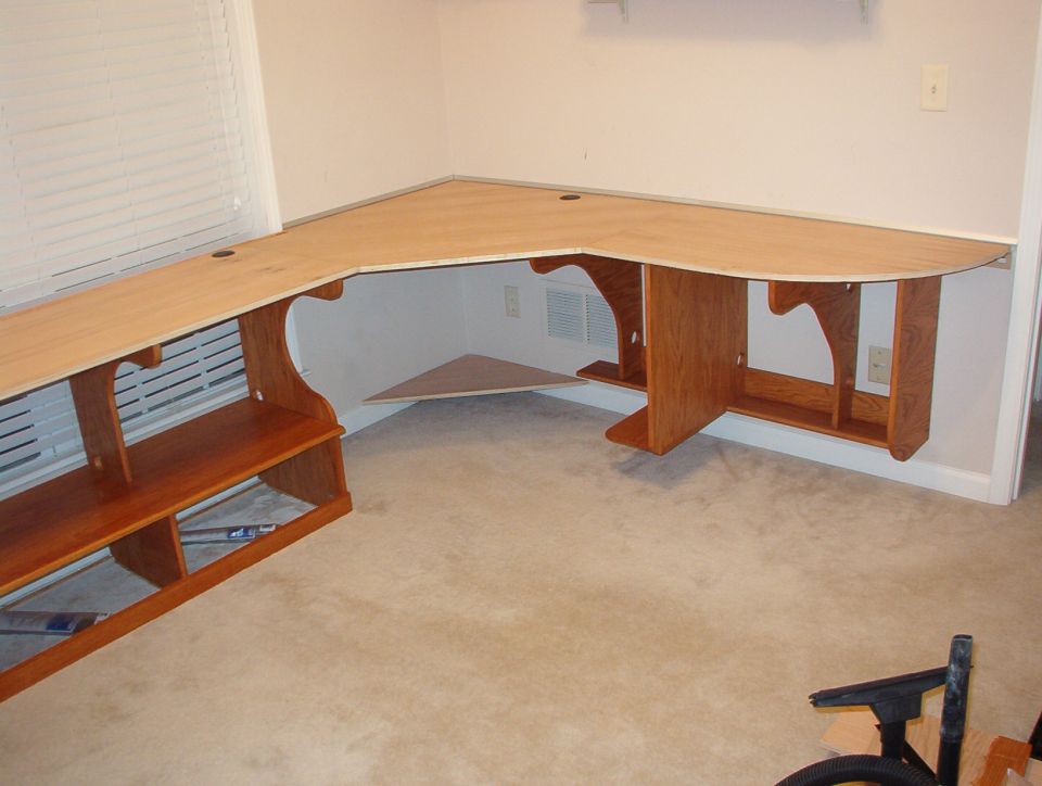 The desktop is fully glued down now, and the aluminum edge is in place.  There's a tiny gap between it and the wood, which will allow me to put on a thick layer of polyurethane after it's stained.