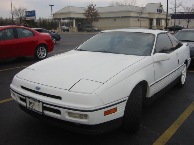 White first-generation Ford Probe with PSU 1 front plate parked in a winter parking lot