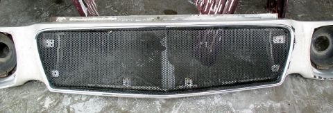 1978 Ford Mustang II - Front grille and headlight assembly, likely from a classic car, a distinctive honeycomb mesh pattern.