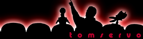 Silhouettes of people and robots on a stage with red lighting and the text 'tom servo'