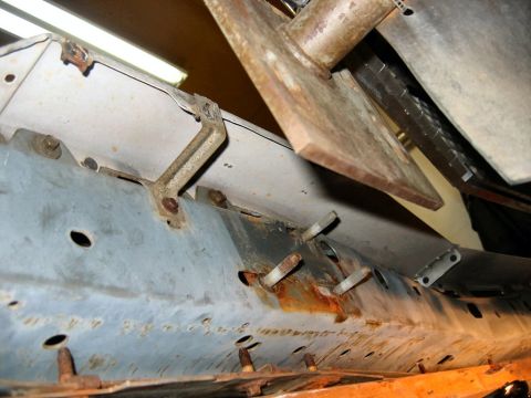 1985 Ford LTD Crown Victoria - This image shows a close-up of a rusted metal frame with bolts and brackets, not a new front bumper.