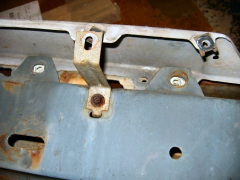 1985 Ford LTD Crown Victoria - Close-up view of rusted mounting brackets, likely for a car bumper assembly.