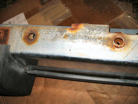 1985 Ford LTD Crown Victoria - This is a close-up view of a corroded car bumper part, showing rust and mounting points.