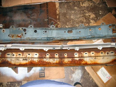 1985 Ford LTD Crown Victoria - Two heavily rusted car bumper parts are shown laid out on a surface of cardboard.