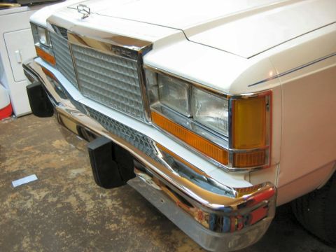 1985 Ford LTD Crown Victoria - Close-up of the front of a white Ford Crown Victoria, showing the grille and bumper details.