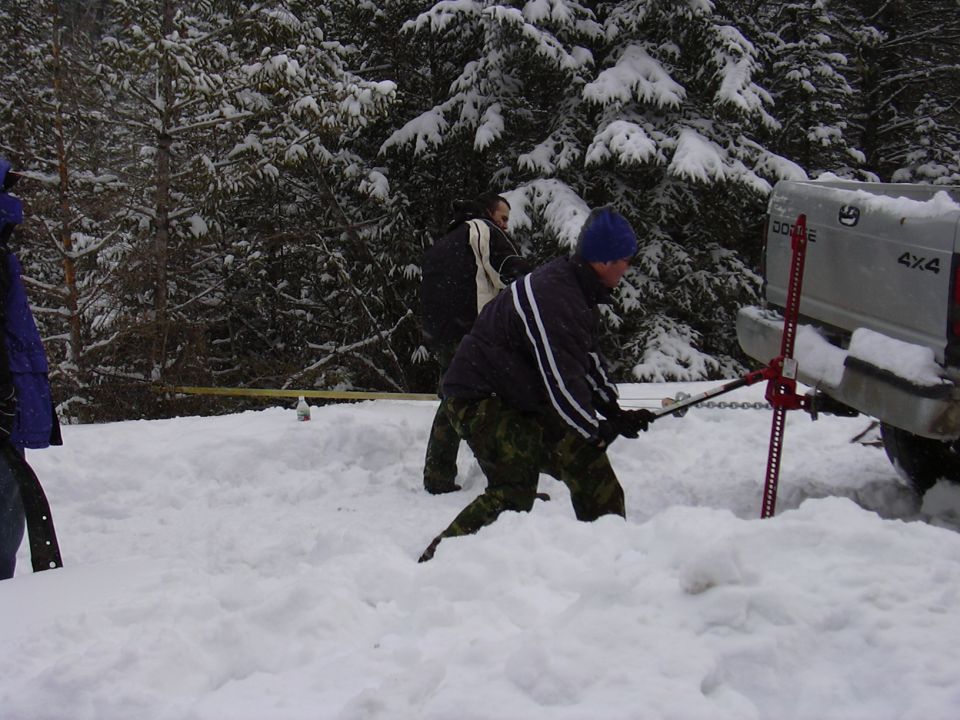 Me off to the the left holding the TTB radius arm to use under the hi-lift to prevent it from sinking in the snow.