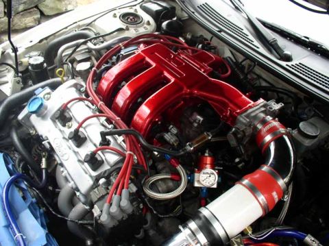 1996 Ford Probe - Close-up view of a modified engine bay, showing custom intake and engine components.