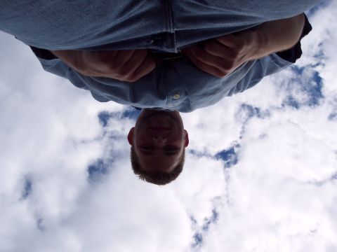 2001 Ford Crown Victoria - A man's face and torso are visible against a backdrop of clouds.