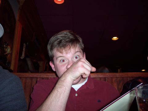 2001 Ford Crown Victoria - A man is seen with his hand covering his face while looking at the camera.