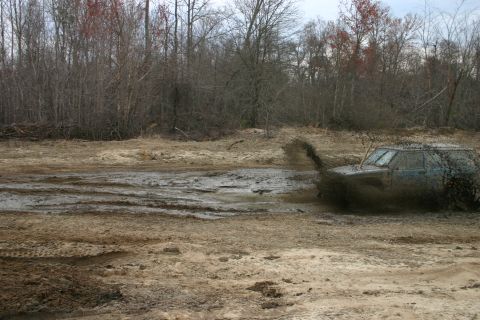 1989 Ford Bronco - This 1989 Ford Bronco navigates a muddy off-road course, kicking up a spray of dirt.