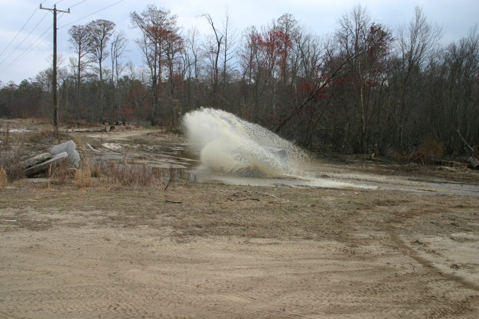 SUV driving through water splash
