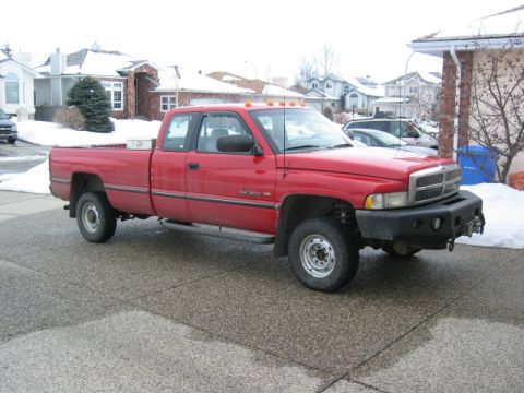1996 Dodge 2500 - A red 1996 Dodge 2500 pickup truck is parked in a driveway during winter.