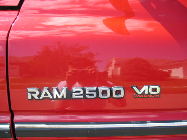 Close-up of a red Dodge Ram 2500 Magnum V10 emblem on the rear quarter panel