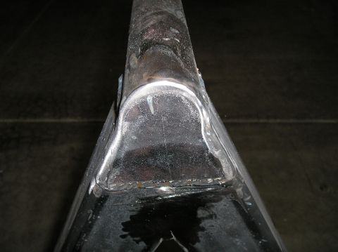 1993 Ford Bronco - A close-up view of a metal component, likely part of a vehicle's frame or suspension system.