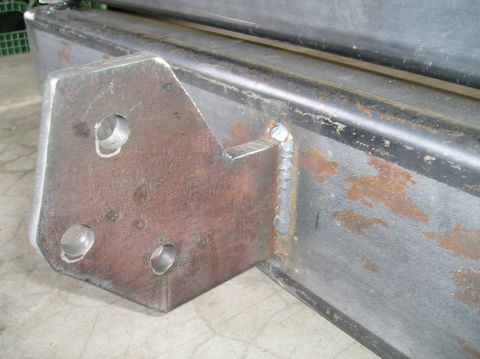 1993 Ford Bronco - Close-up of a custom metal bracket with three mounting holes, welded onto a frame. Text from Supermotors.net is visible.