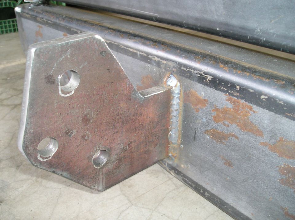 Bare steel fabricated bumper with three-hole mounting bracket welded to end