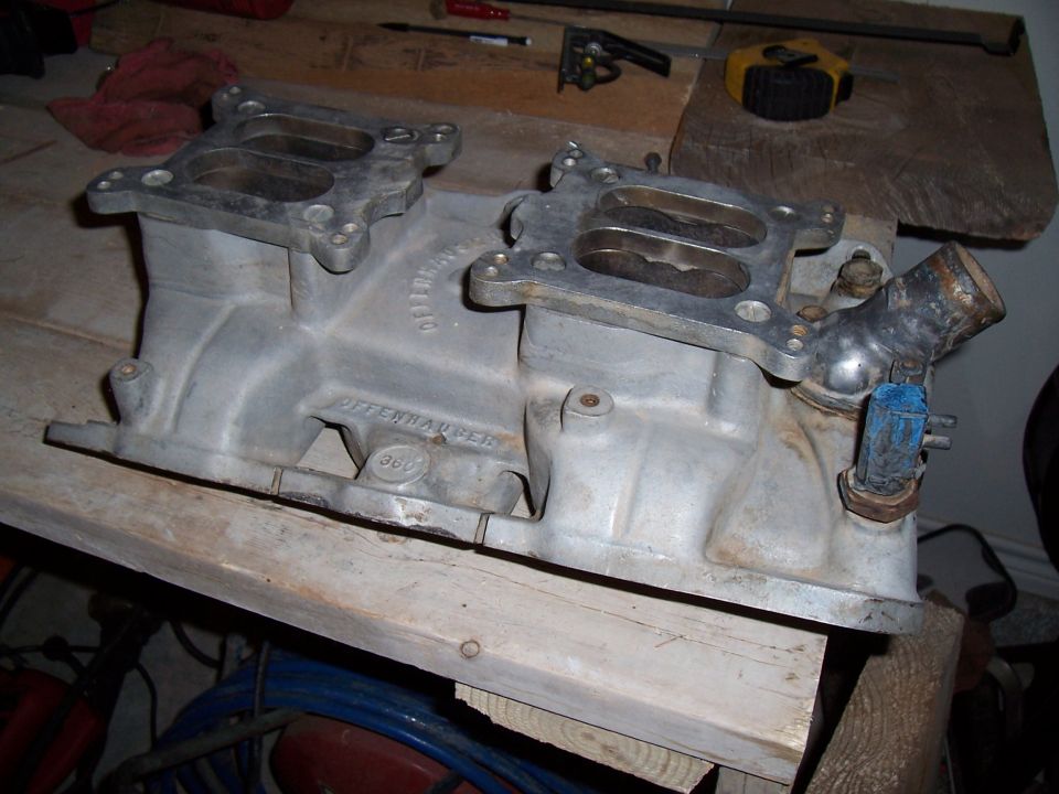 Offenhauser intake manifold with '360' cast into it, resting on wooden planks
