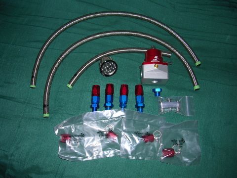 1996 Ford Probe - AFPR kit includes braided hoses, fittings, and a red and silver fuel pressure regulator.