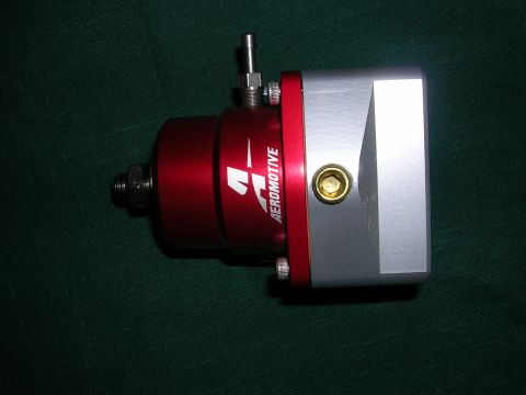 1996 Ford Probe - Aeromotive fuel pressure regulator shown on a dark green background.