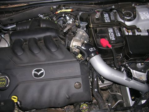 2004 Mazda 6 - Engine bay view of a 2004 Mazda 6, highlighting the V6 engine and an aftermarket intake system.