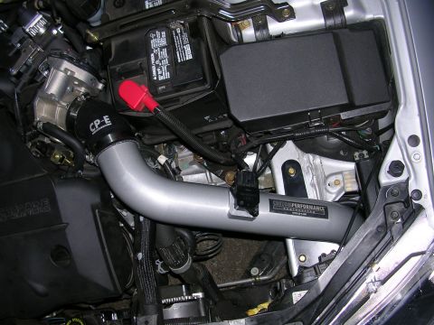 2004 Mazda 6 - Close-up of engine bay components, including a custom intake system and battery.