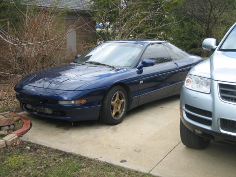 1995 Ford Probe - A blue 1995 Ford Probe is seen from a three-quarter front angle, parked on a driveway.